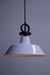 Pendant light with white shade and black pendant cord with disck