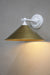 White steel arm wall light with bright brass shade