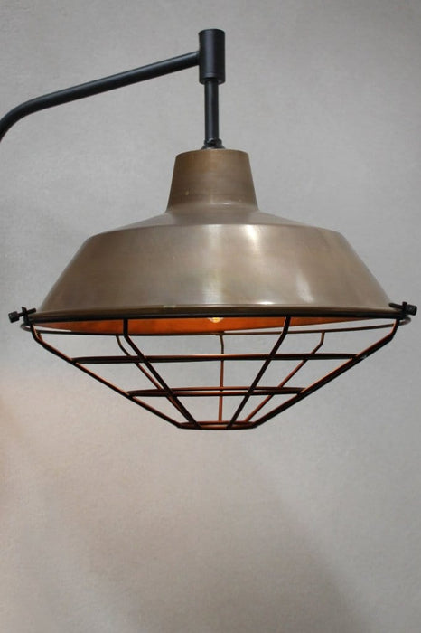 Aged brass wall light with cage guard