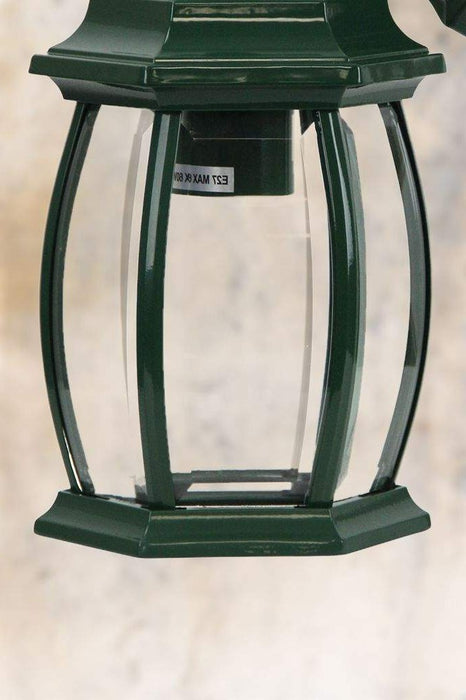 Close-up of outdoor wall light in green finish. 