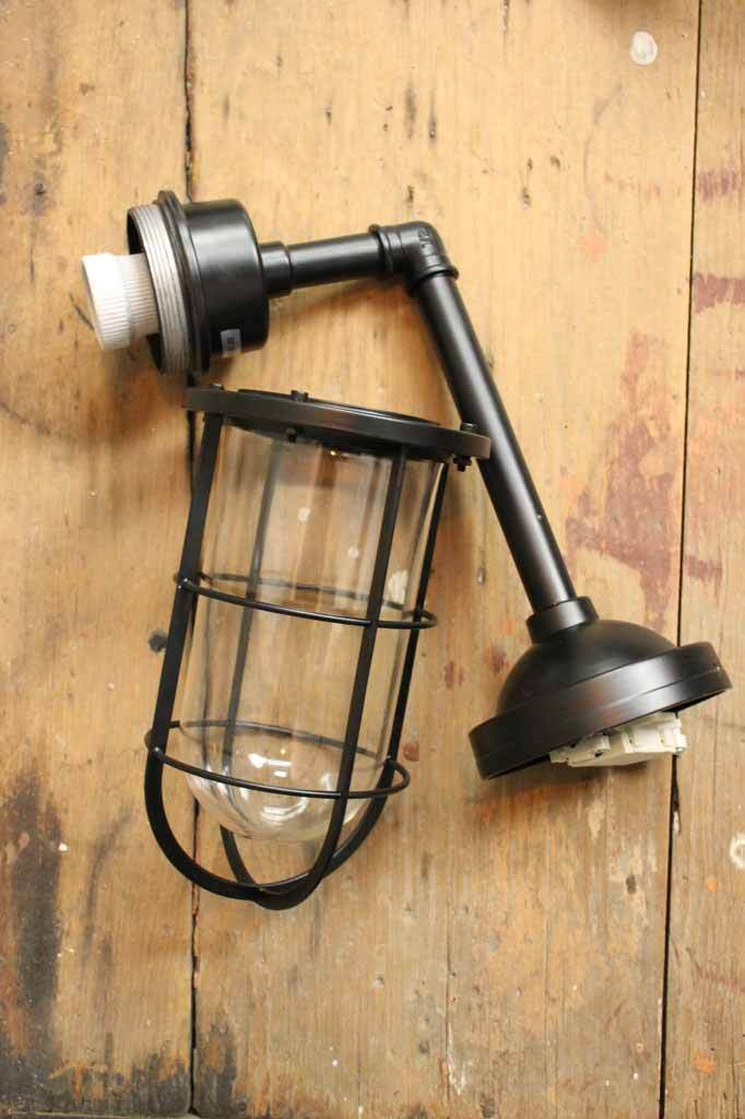A black outdoor wall light a timeless modern update to any shop front cafe interior or home entrance