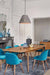 Concrete basket pendant above a vintage timber dining table