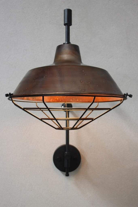 Black cage cover for copper shade wall light