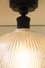matt black metal lampholder atop rippled glass dome shade