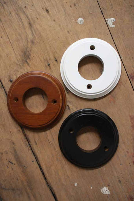 Black, white and natural wood mounting blocks for ceiling roses