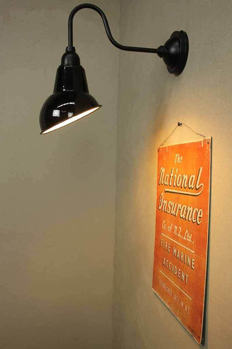 Black shade is angled to illuminate a wall or object such as a menu sign or artwork.