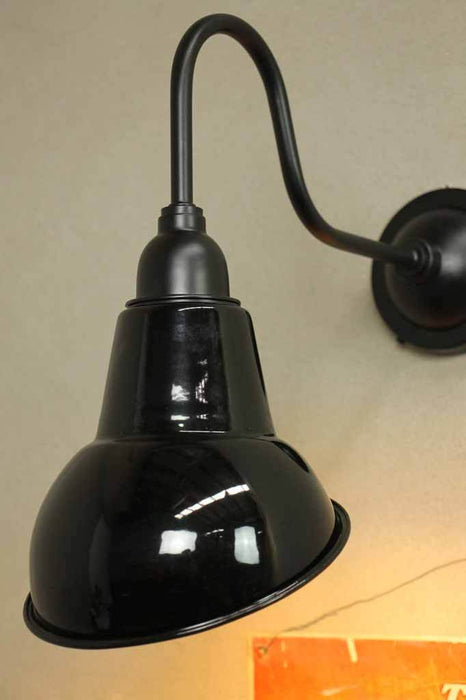 Black steel shade on sign wall light. designed to highlight a wall or