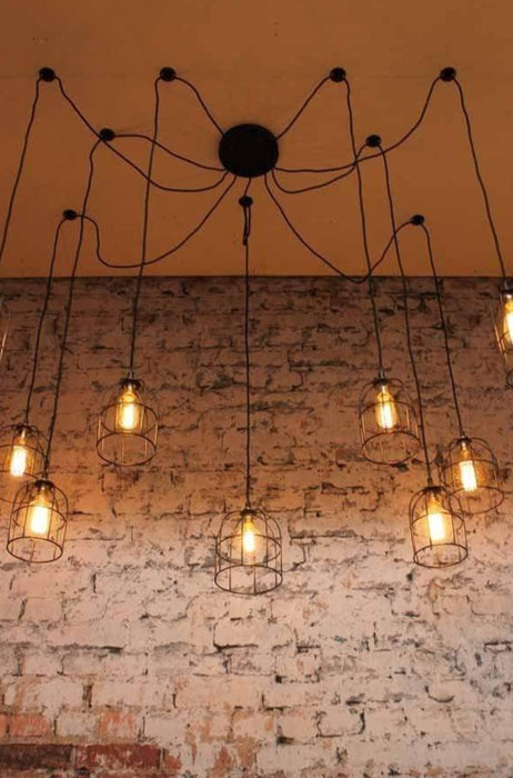 Cage industrial pendant light comes with ceiling plates to support cords draped hung or spread in different combinations