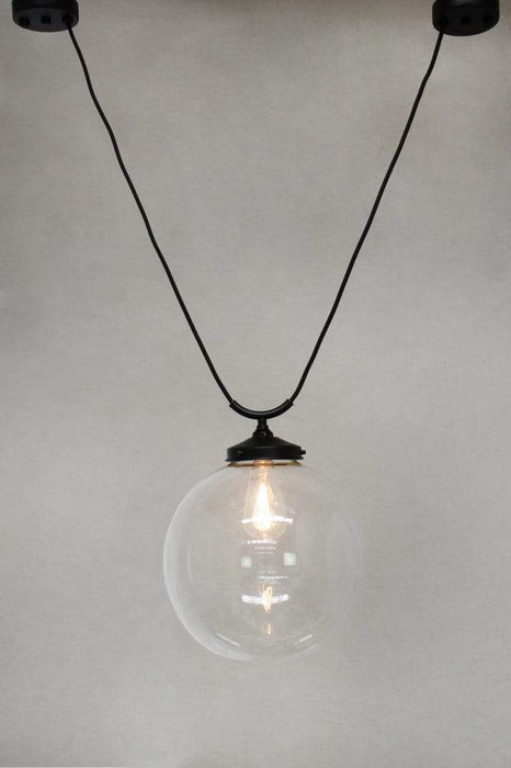 Large round clear glass shade with trapeze pendant cord