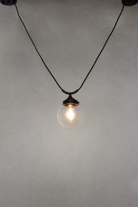 Small round clear glass shade with trapeze pendant cord