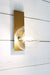Gold brass wall light mounted with clear glass shade at bottom end