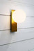 Opal glass wall light with gold brass face plate