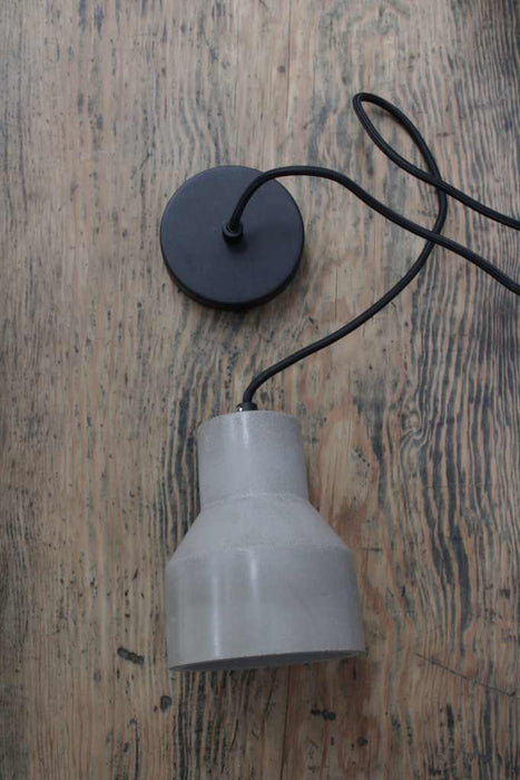 Concrete pendant light with black fabric cord and black ceiling rose