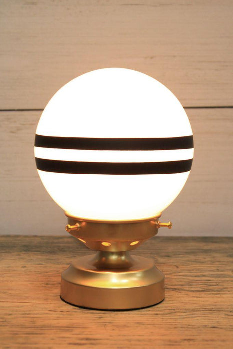 glass ball lamp with gold/brass base and 2 stripes