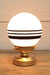glass ball lamp with gold/brass base and 3 stripes
