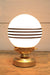 glass ball lamp with gold/brass base and 4 stripes