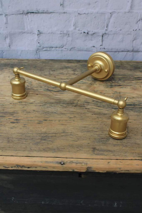 Gold double arm wall light