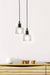 Two handblown glass pendant lights hanging above an armchair