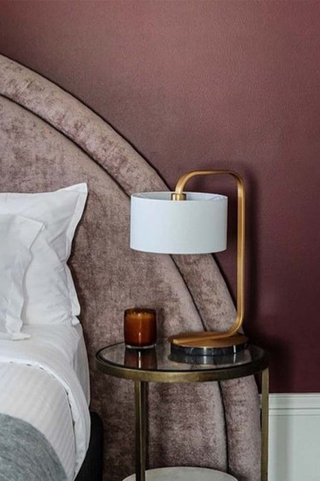 Black and gold table lamp in bedroom