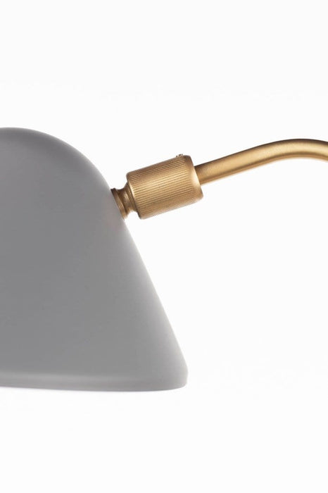 Detail of gold fixture connecting to satin grey lamp shade
