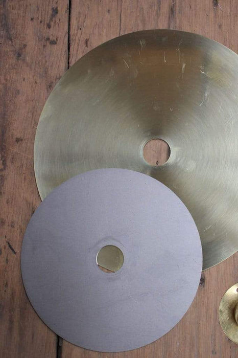 Large brass and small steel discs