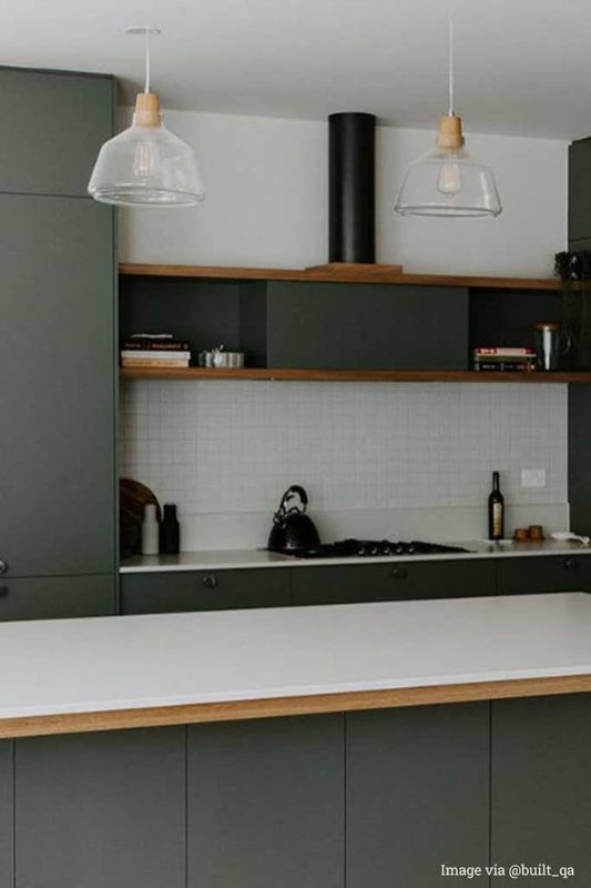 Wood top glass light pendant over kitchen benchtop.