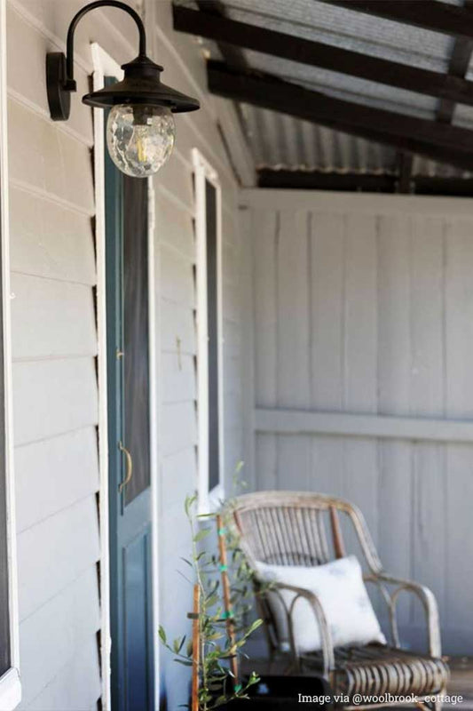Victorian-styled-outdoor-wall-light in the front porch door.