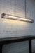 Linear light comes with a matt black finish and has a chain and cord suspension.