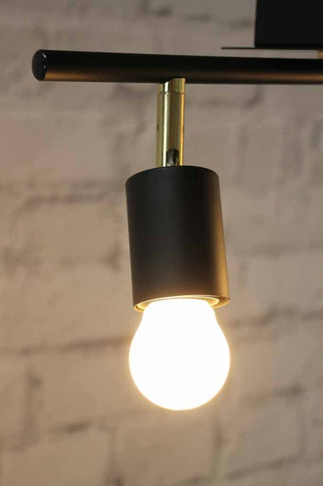 Matt black on brushed brass detailing with vintage exposed style bulb
