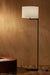 Contemporary floor lamp with white shade in a earth toned background 