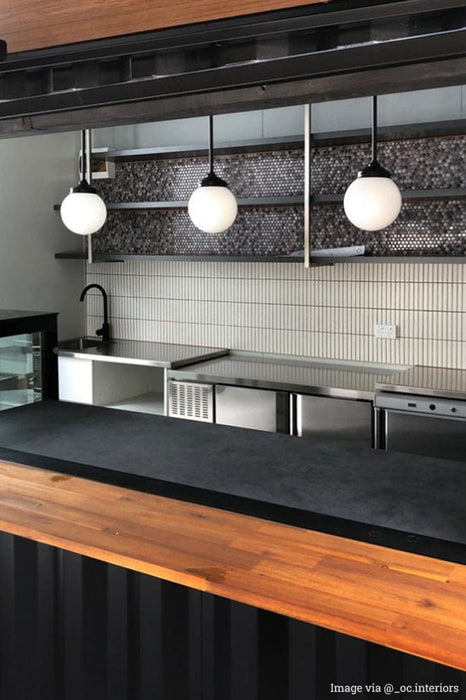 3 Glass Balls Pole Pendants in a commercial kitchen.