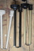 White, black and gold rod pendant poles on a wood table