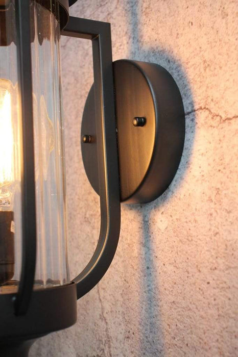 Round metal wall sconce for outdoor lighting