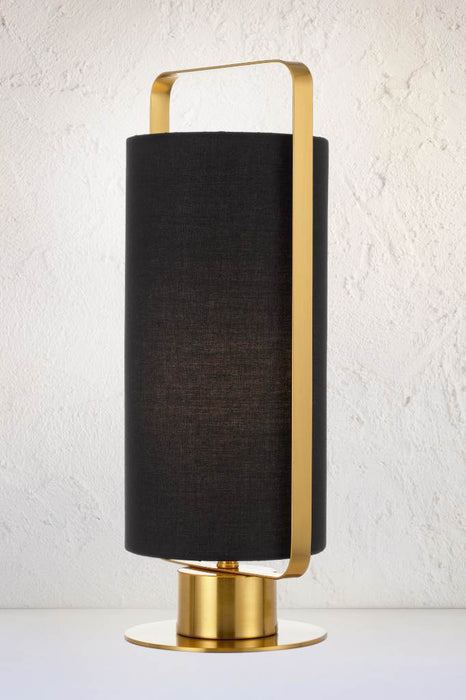 Mid-century style lamp with gold base and fixtures with black fabric cylindrical shade