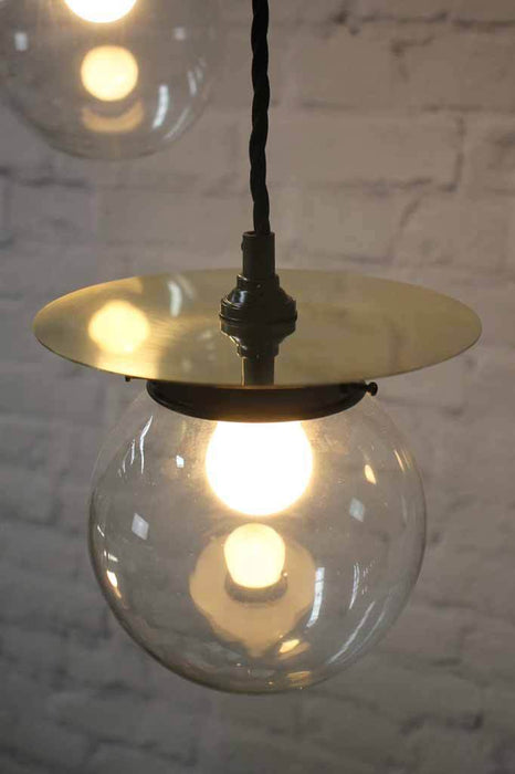 Solid brass disc on clear glass shade pendant