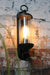 Tall black outdoor wall light with a cylindrical glass light shade