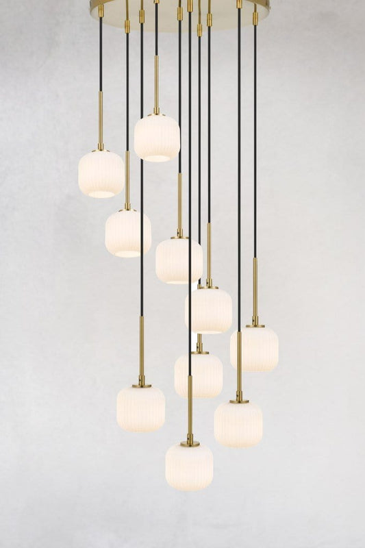 Ten opal glass pendants hanging from a gold ceiling rose