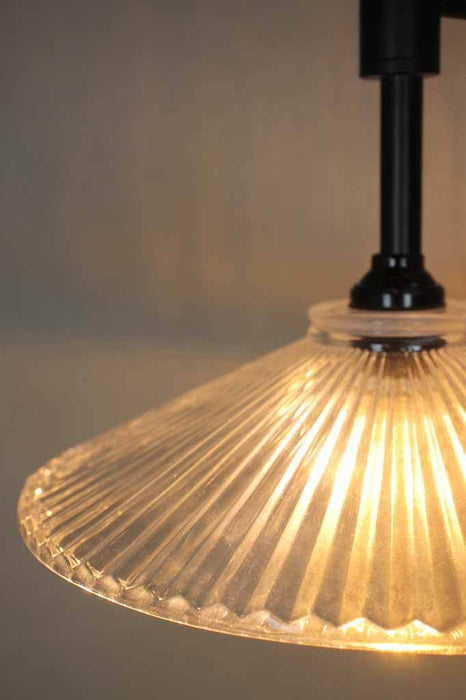Thick shallow conical glass shade spreads light