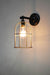 Wall mounted cage light with gold brass finish