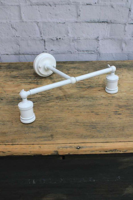 Double swivel arm wall sconce in white finish