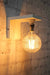 White wall sconce large exposed bulb light