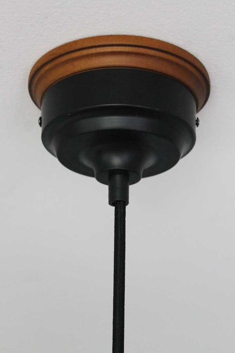 wooden mounting block on black ceiling rose